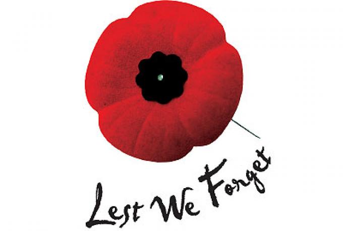 A Remembrance Day poppy with the words "Lest We Forget"